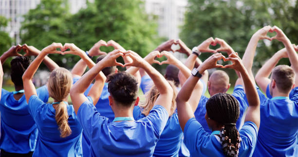 Diverse Young Charity Group Making Hearts Using Hands